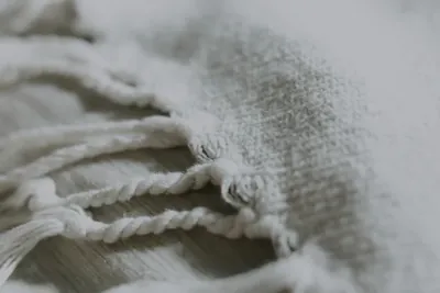 A textured, natural linen fabric, symbolizing a connection to sustainable materials.